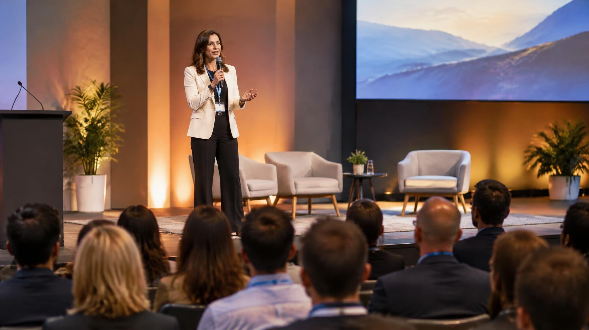 Speaker on stage in front of a conference audience